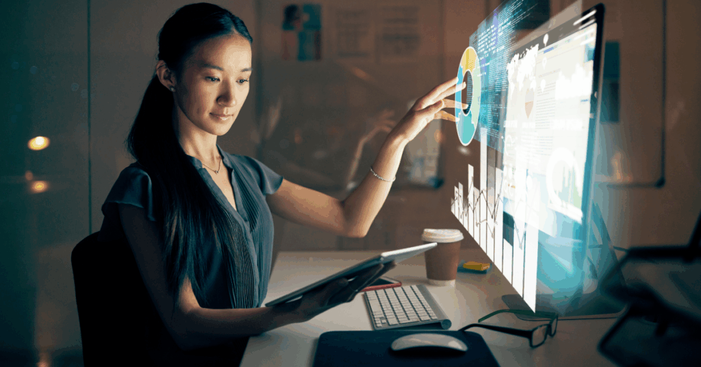 Woman using futuristic data visualizations to analyze software delivery performance and deployment frequency.