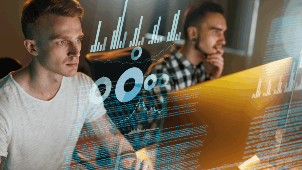 Two male software developers working on computers with overlaid digital charts and analytics data, software developer vs software engineer