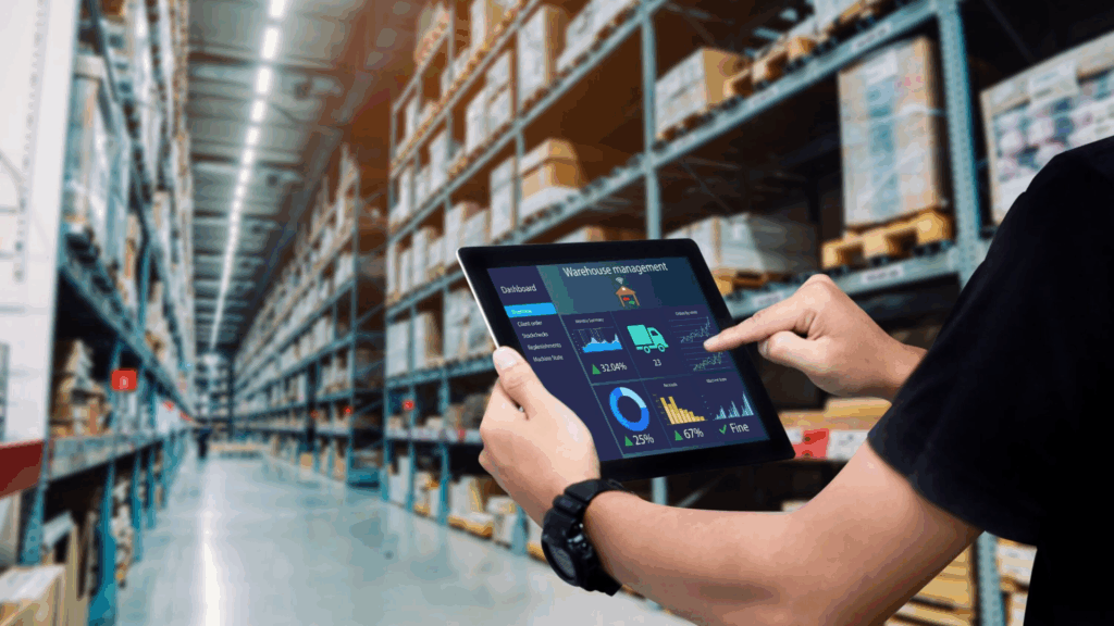 Individual using a warehouse management system on a tablet in a logistics facility, showcasing digital operations efficiency