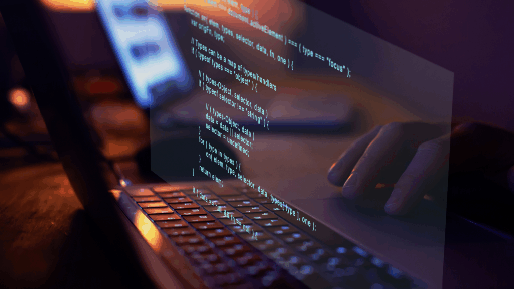 Close-up of a laptop screen with reflected code, highlighting secure and customized software development for the fintech industry.
