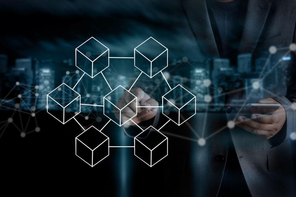 parallelstaff- A person in a suit holds a tablet and uses a stylus, with a digital, glowing blockchain network diagram overlaid on a blurred cityscape—reflecting how businesses find blockchain developers for cutting-edge solutions.