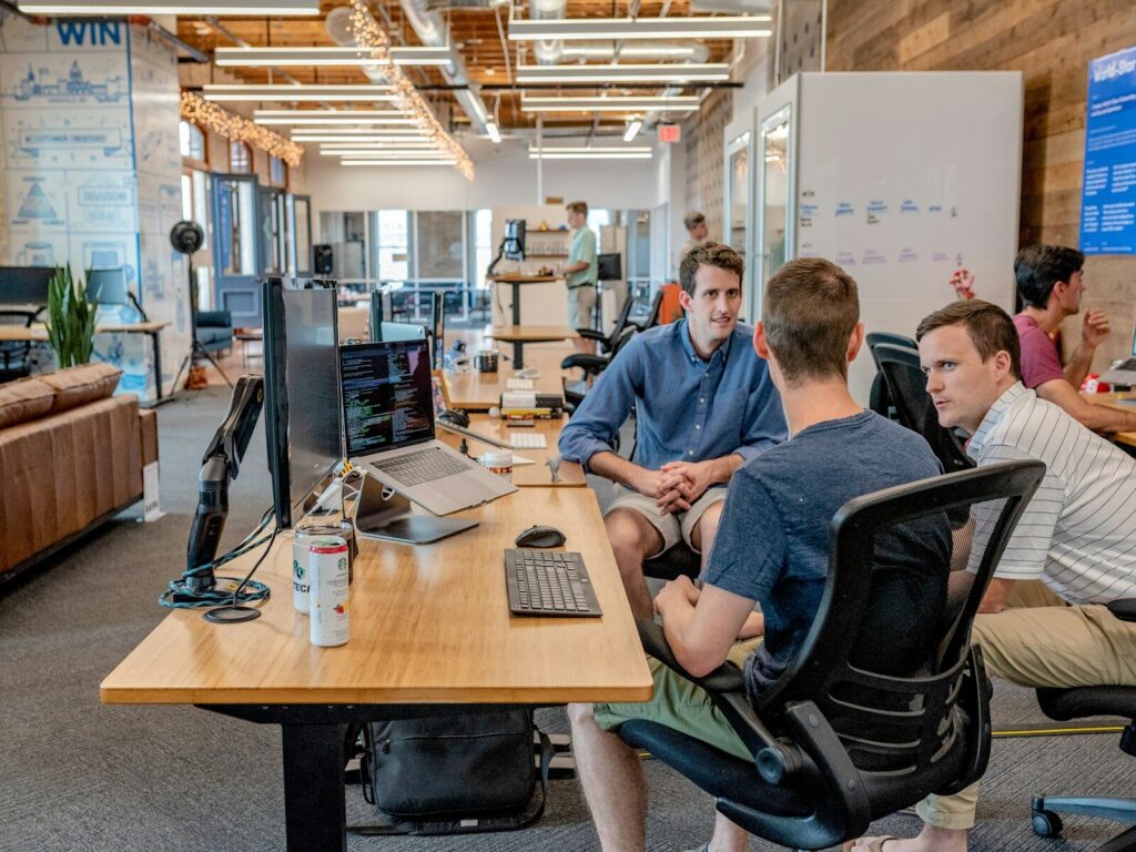 three men sitting software development on nearshore