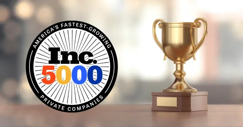 parallelstaff- A gold trophy next to a badge that reads Americas Fastest-Growing Private Companies Inc. 5000, celebrating ParallelStaff’s achievement. The background is softly blurred with warm lighting.