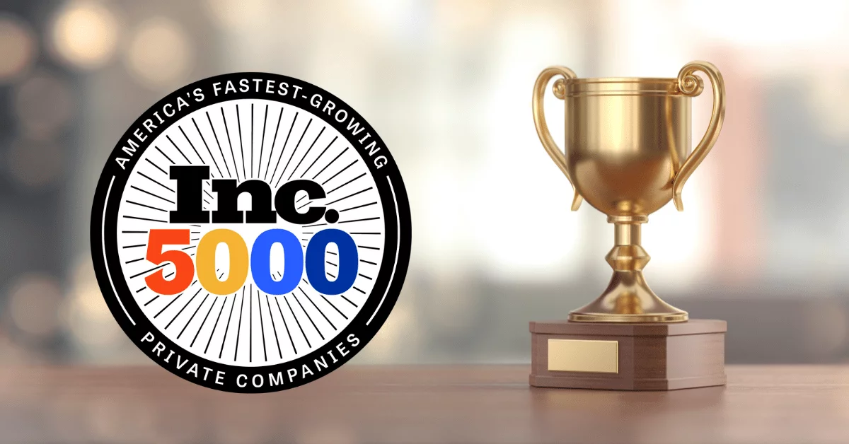 parallelstaff- A gold trophy next to a badge that reads Americas Fastest-Growing Private Companies Inc. 5000, celebrating ParallelStaff’s achievement. The background is softly blurred with warm lighting.