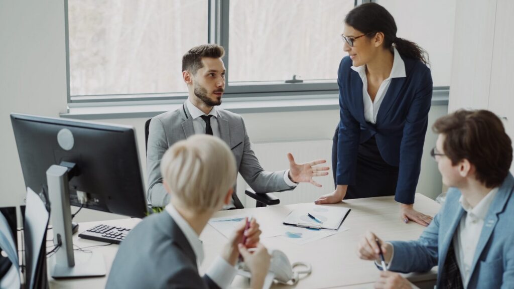 Business professionals collaborating in a modern office meeting.