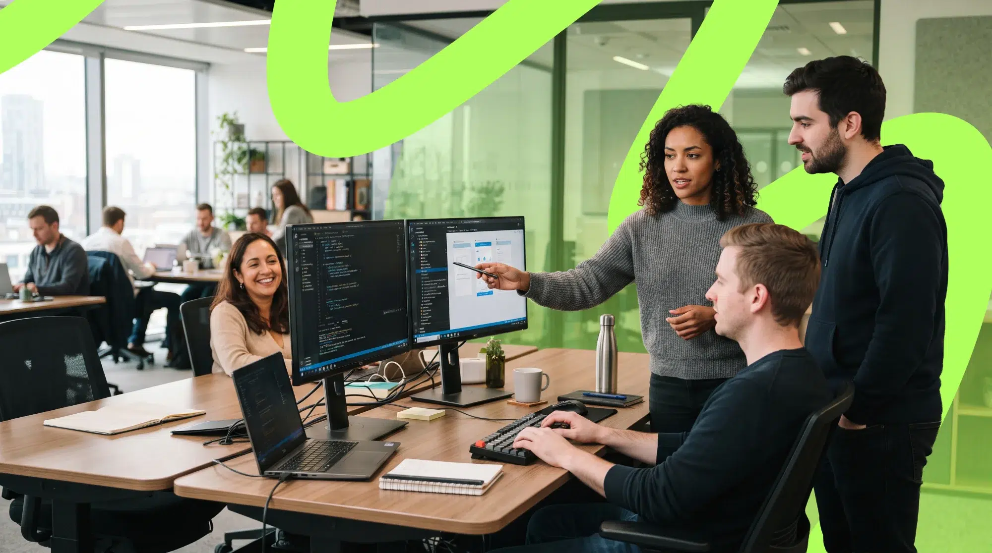 parallelstaff- Four colleagues collaborate at a desk with computers in a modern, open-plan office. One person points at a monitor while others watch. Bright green lines are overlaid on the photo.