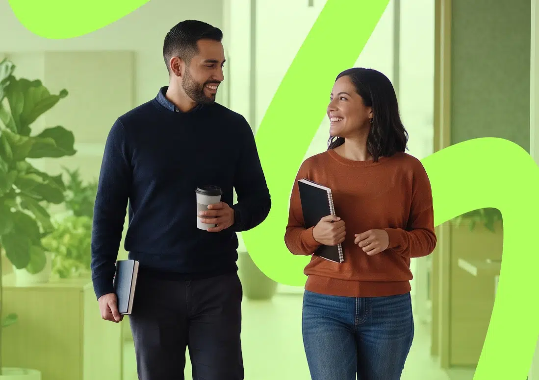 parallelstaff- Two people smiling and walking indoors, each holding notebooks. One person carries a coffee cup. There is a bright green abstract shape in the background.