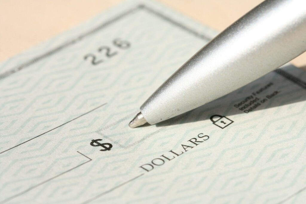 Pen poised over a check, ready to write