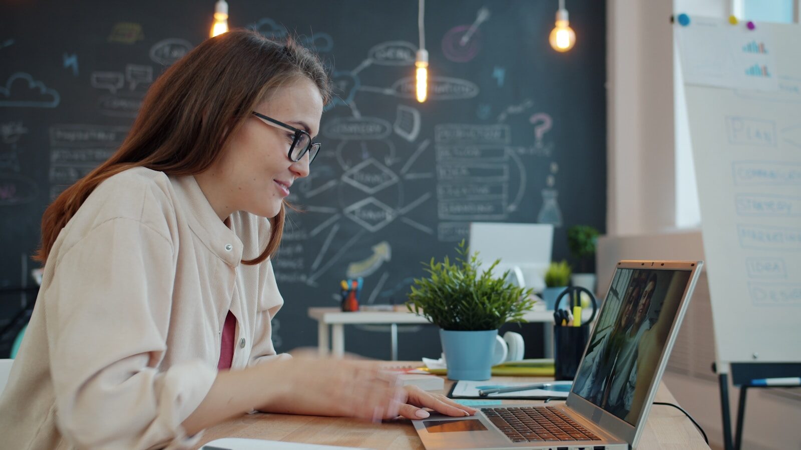Woman working on a laptop in a modern office