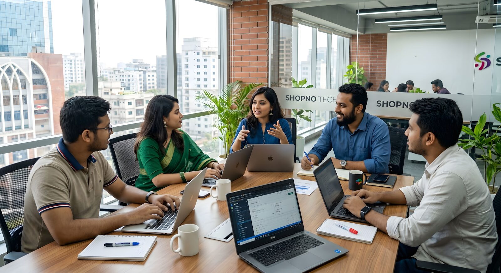 Five colleagues collaborating around a table in a modern office